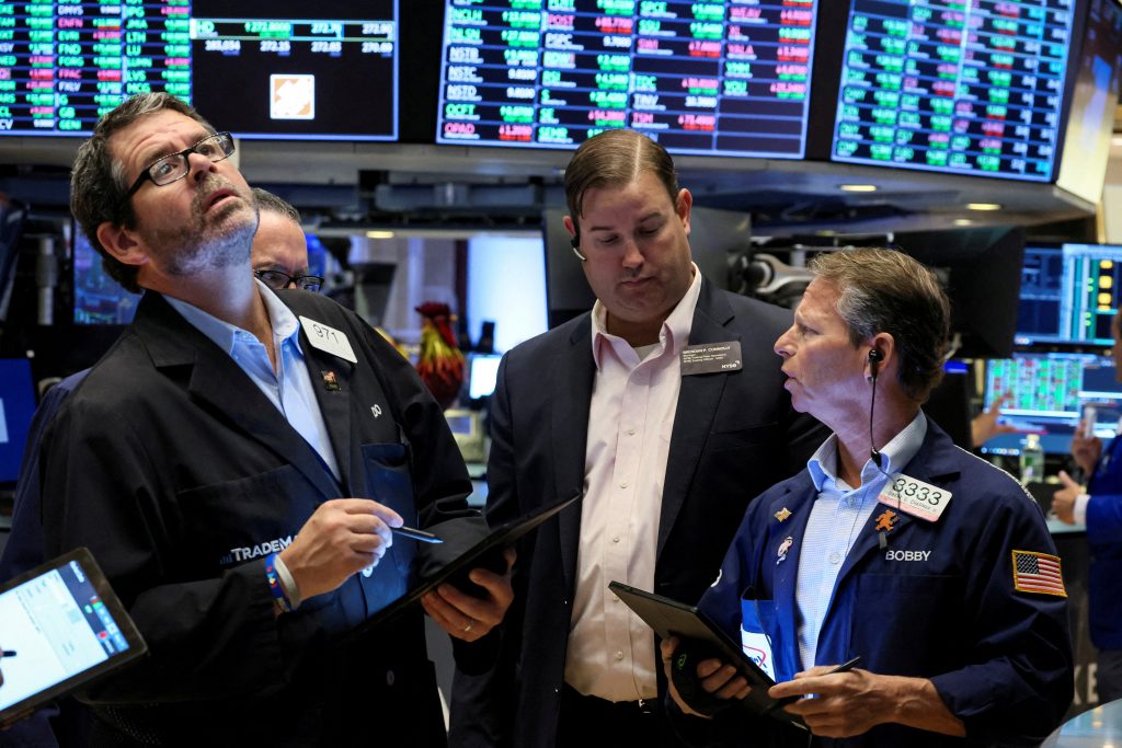 FILE PHOTO: Traders work on the floor of the NYSE in New York thumbnail